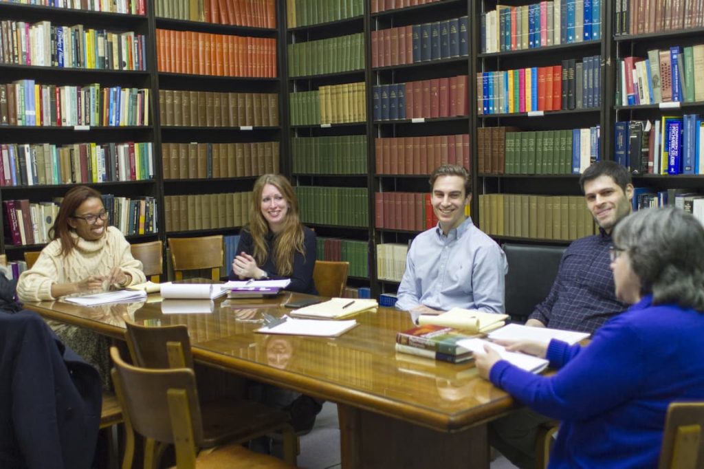 Psychoanalysts sit and learn and discuss developments in the field